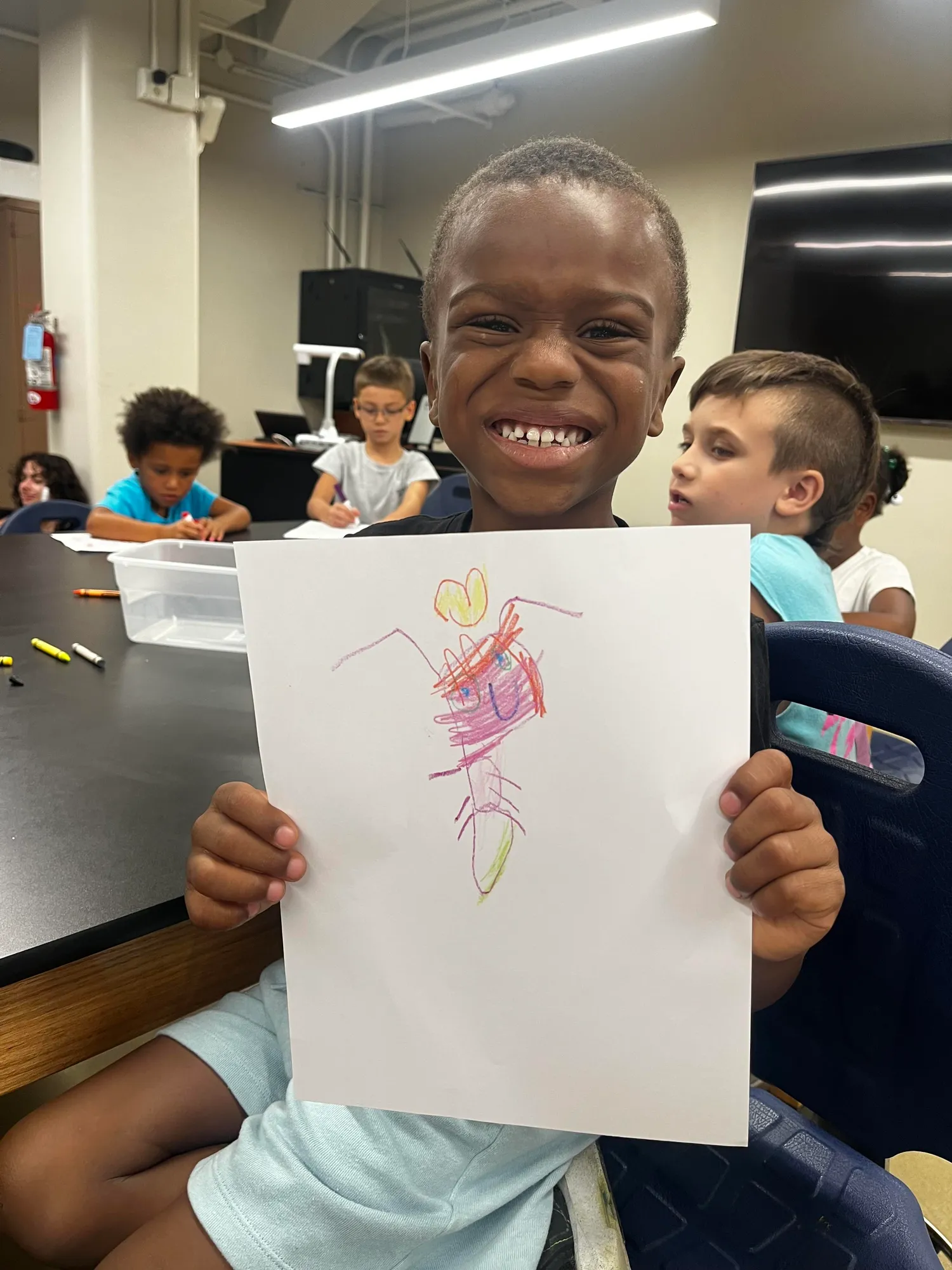 Smiling youth participant showing their colorful drawing in a group session