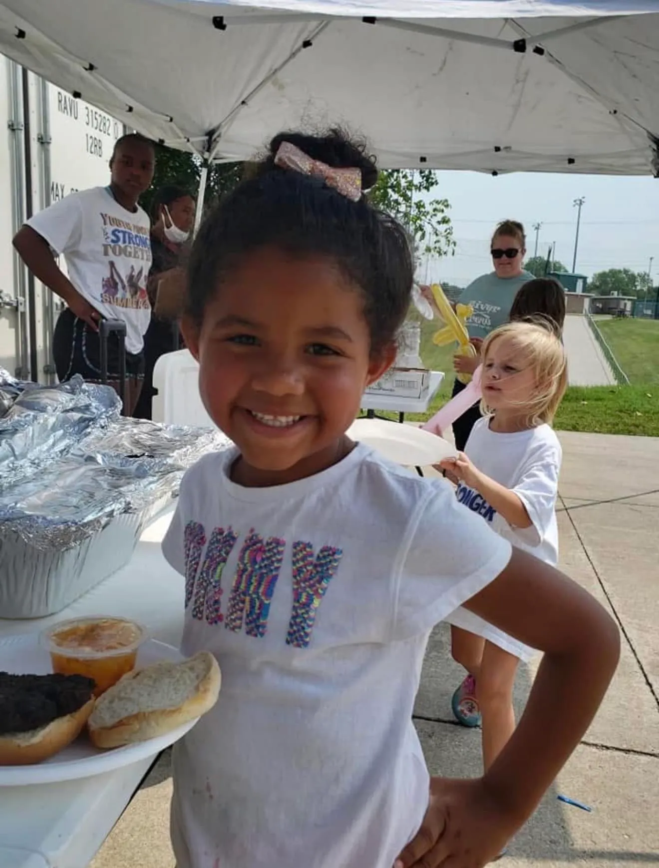Youth Power child smiling at a community event