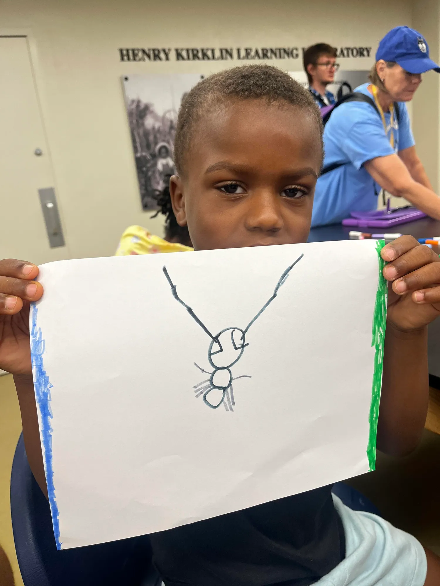 Youth participant showing their artwork at a Healthy Choices program session